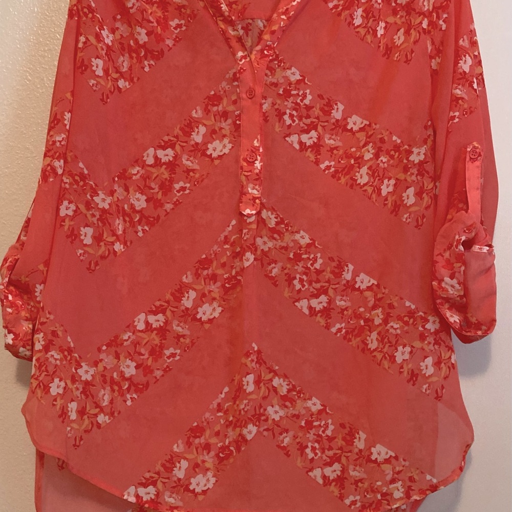 Sheer melon colored blouse with flowers in deeper colored melon, red & white.